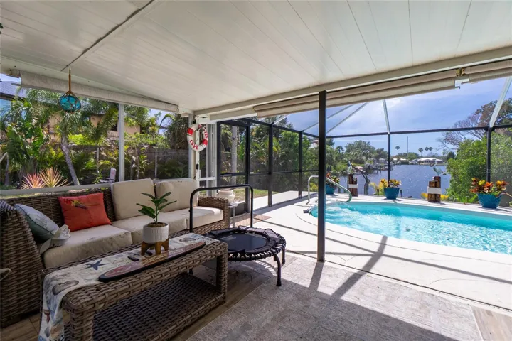 Lanai (Screened Porch overlooking pool and water view down canal.