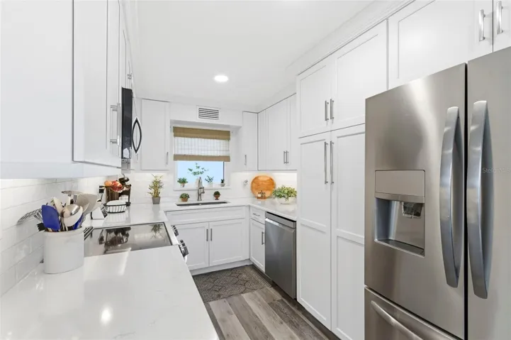 kitchen with quartz counters, stainless steel appliances and pantry