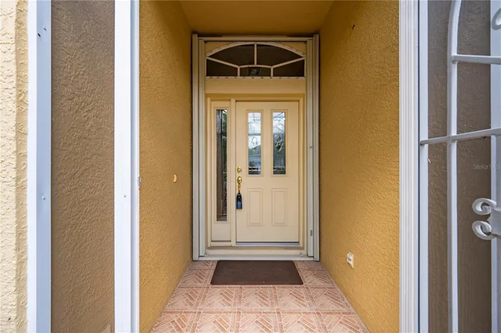 Front door has beveled glass, accordian storm shutters