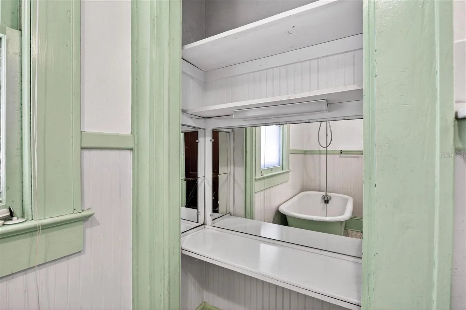 Built in Vanity w/Mirrors Reflecting the Antique Tub