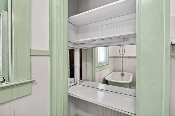 Built in Vanity w/Mirrors Reflecting the Antique Tub