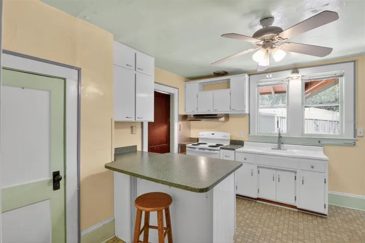 Kitchen with windows over sink and movable island