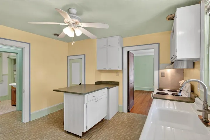 Kitchen view to dining room and hallway to bed & bath