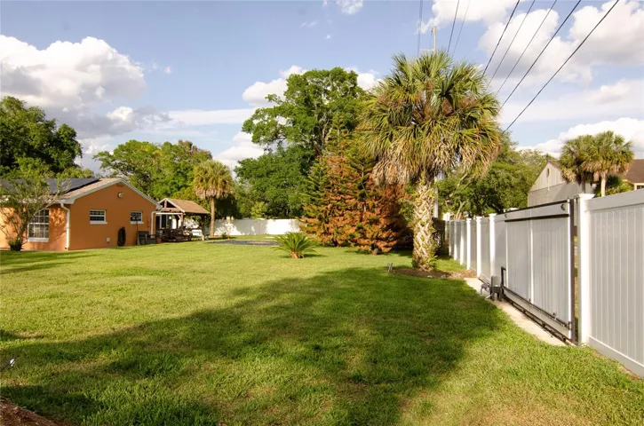 Private backyard access featuring a remote-controlled gate, offering added security and convenience.