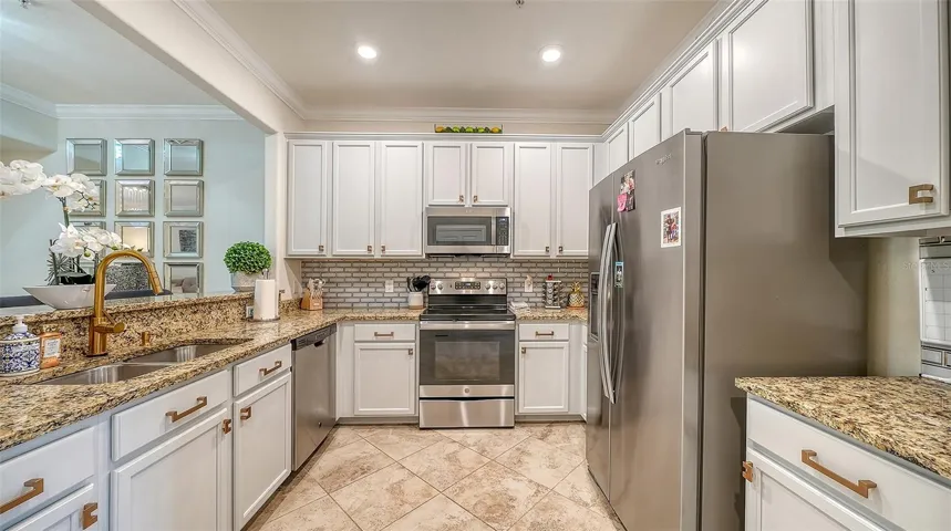 Kitchen with stainless steel appliances, granite countertops, solid wood cabinetry