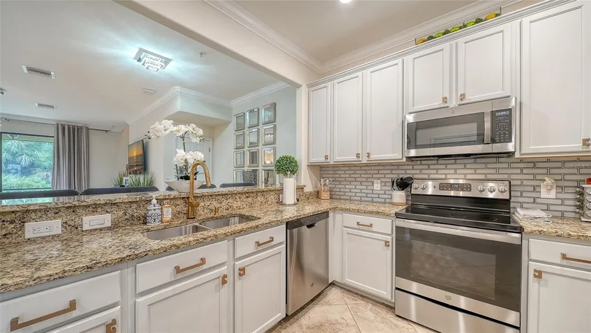 Kitchen with Stainless steel appliances, granite countertops and solid wood cabinatry