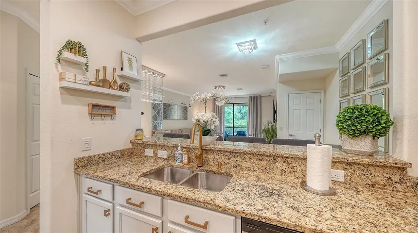 Kitchen view to Dining and Living area featuring solid wood cabinets, granite countertops