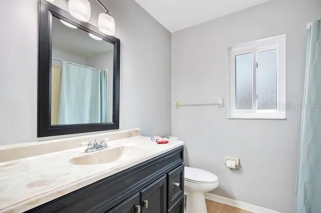 Primary bathroom with functional layout and ample space.