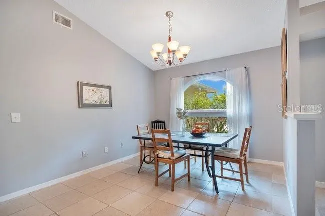 Additional view of the dining room highlighting abundant natural light.