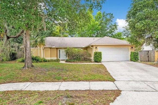 Situated on a generous quarter-acre lot with a wide driveway and attractive front presence.