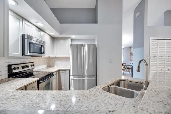 Efficient kitchen featuring granite counters and a seamless connection to the family room.