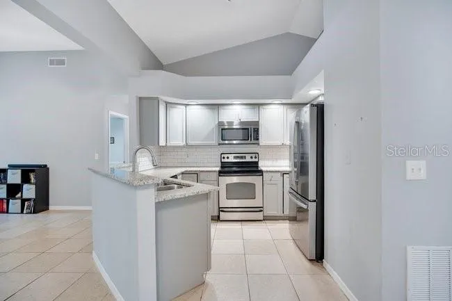 Functional kitchen with granite countertops and open concept to the family room.