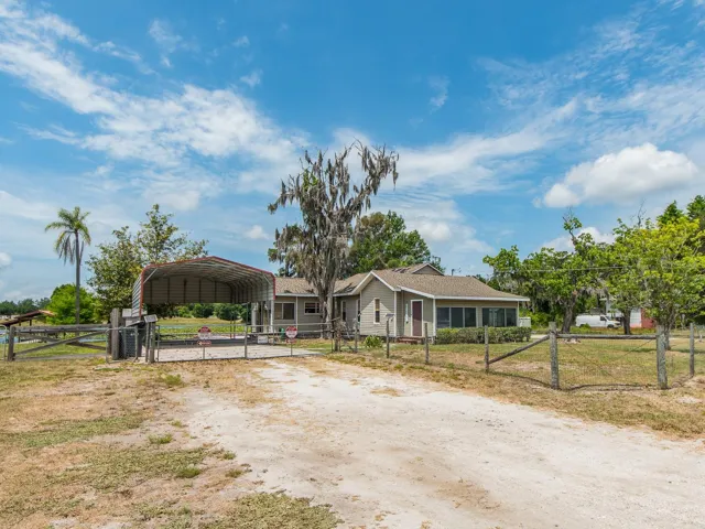 Front exterior of home with driveway and carport