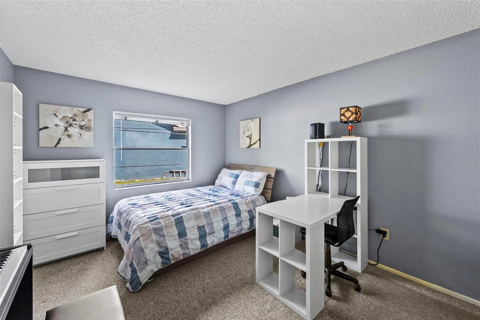 Secondary bedroom with space for sleeping, studying, or guests.