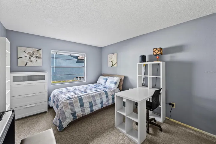 Secondary bedroom with space for sleeping, studying, or guests.