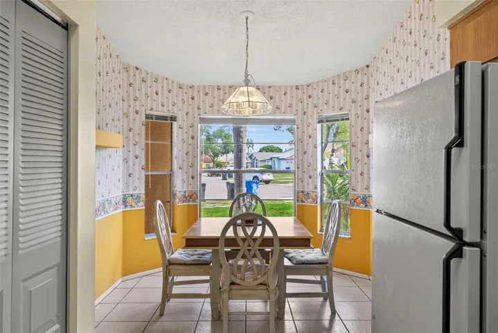 Bright breakfast nook with bay windows and IN-KITCHEN PANTRY for add'l storage! overlooking the front yard.