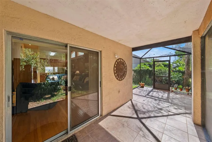 Covered lanai with sliding glass door access from the home.