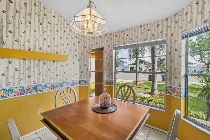 Bright breakfast nook with bay windows overlooking the front yard.