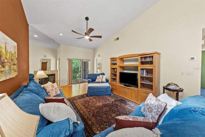 omfortable living room with fireplace and direct patio access.