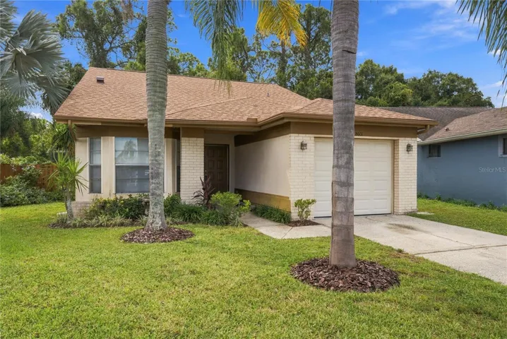*NEW ROOF and Charming curb appeal with mature palms, lush landscaping, and a welcoming front entry.