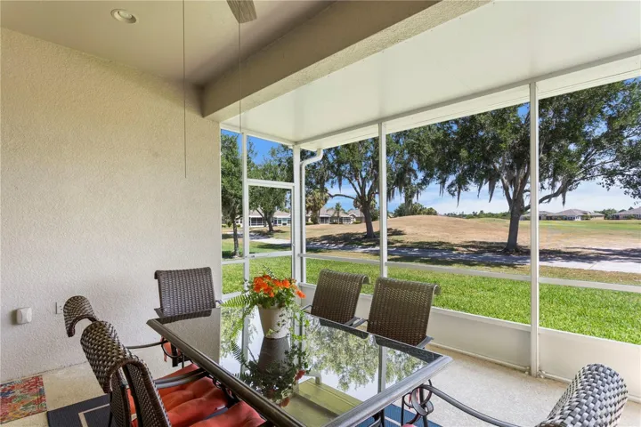 Fully furnished lanai screened in golf course with pond view.