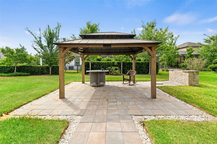 Backyard paved with pergola and Pizza Oven