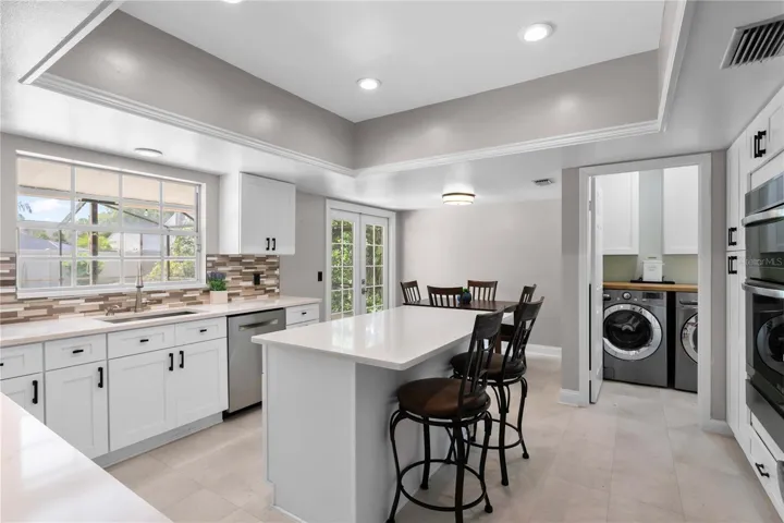 Kitchen remodeled in 2025 with quartz counters and glass tile backsplash