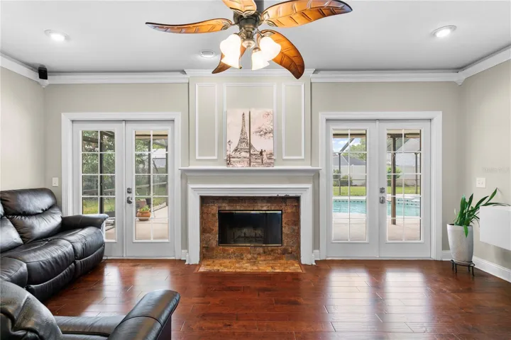Family room features two french doors leading to the screened in pool and lanai