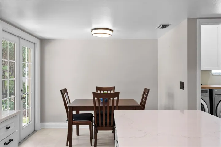 Casual dining area with french doors leading to lanai and pool