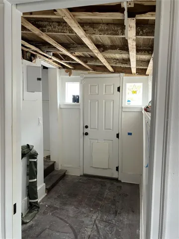 View from bedroom 3 looking at laundry space and door to backyard courtyard.