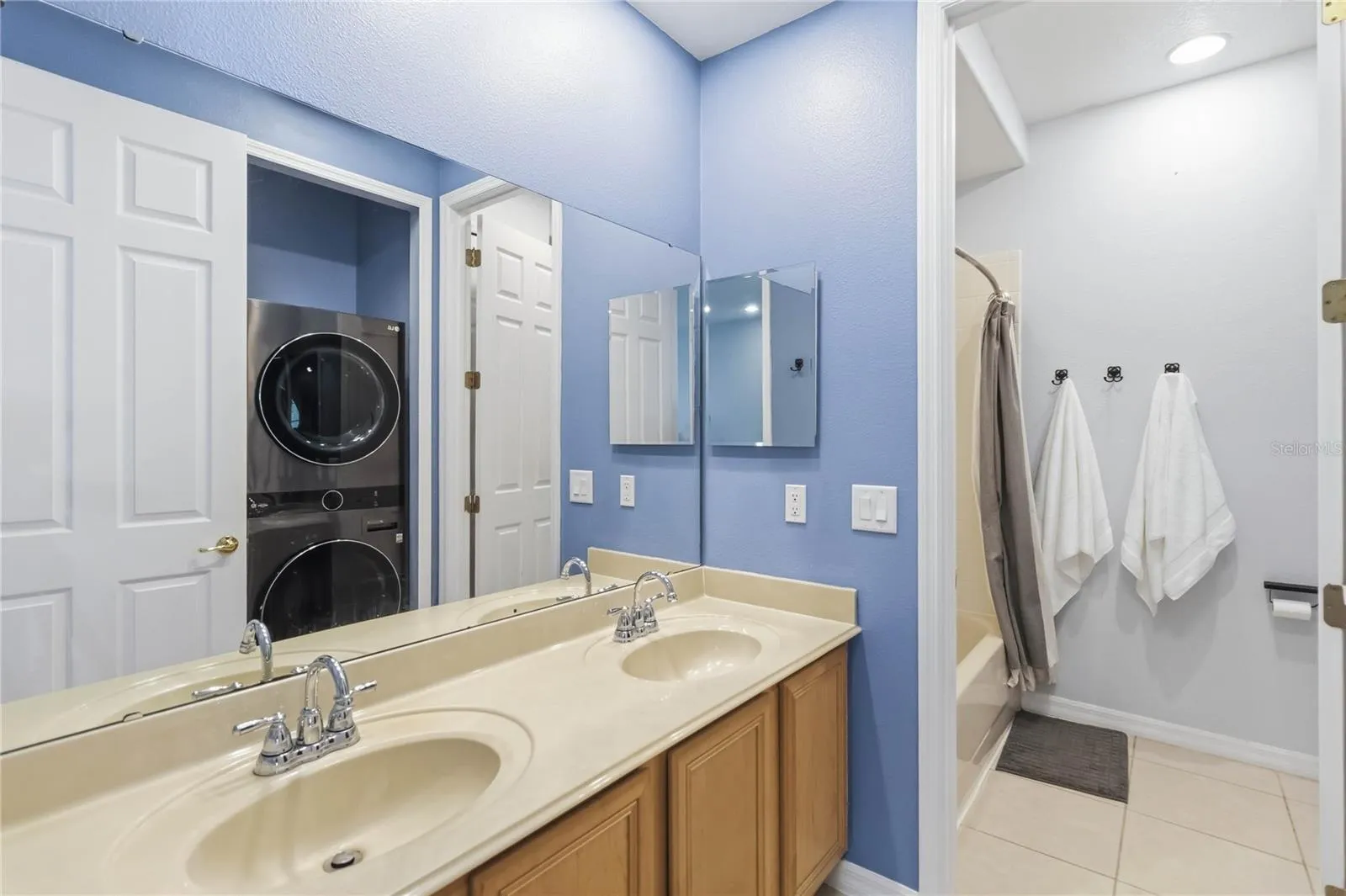 Guest Bathroom with laundry area show in the reflection