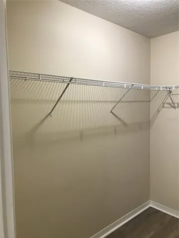 Primary bedroom walk in closet