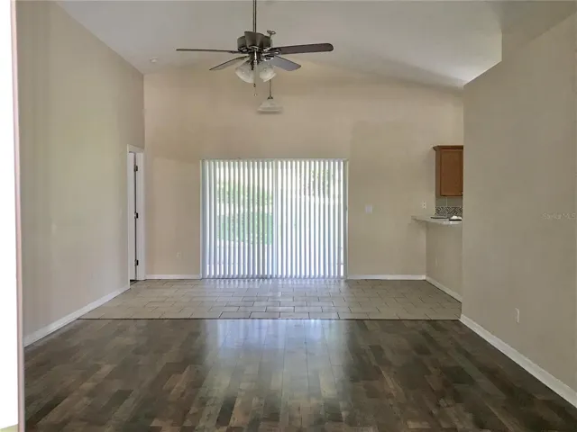 Living Room with sliding glass doors to the roof over screened lanai