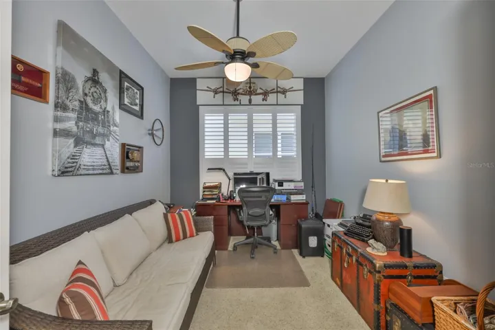Bedroom #2 has a large window with plantation shutters.