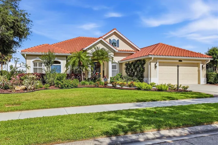 Tropical landscaping surrounds this beautiful home