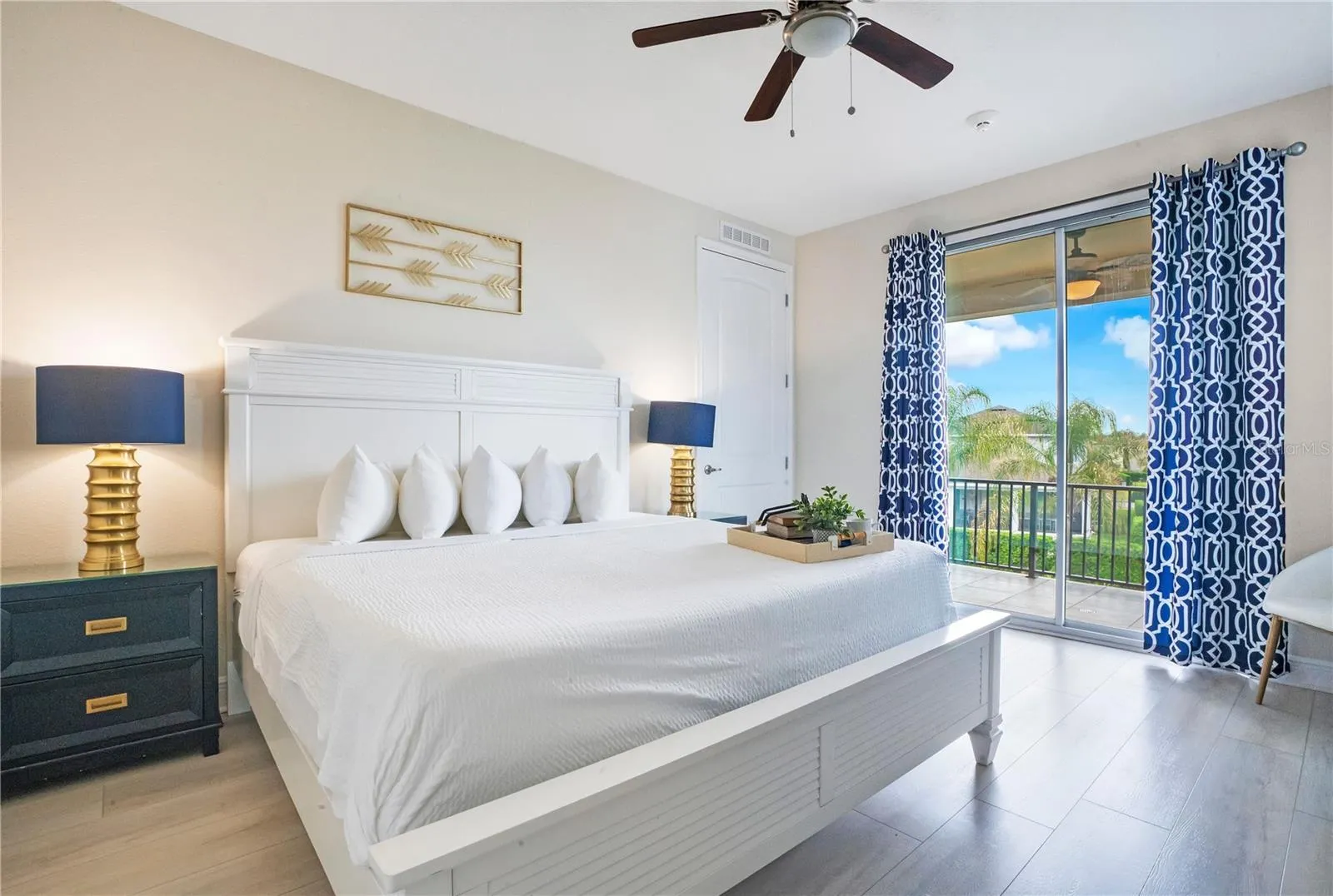 Elegant upstairs primary suite (#8) opening directly to the oversized screened balcony