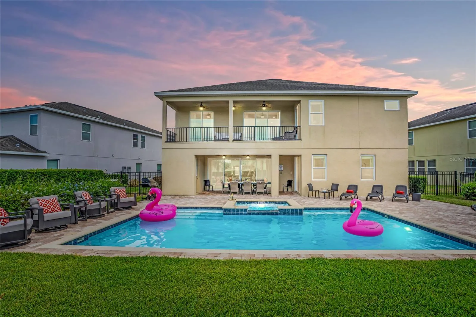 Expansive backyard retreat with heated pool and spa offering the perfect setting for relaxing after a day at Disney or enjoying evenings under the Florida sky