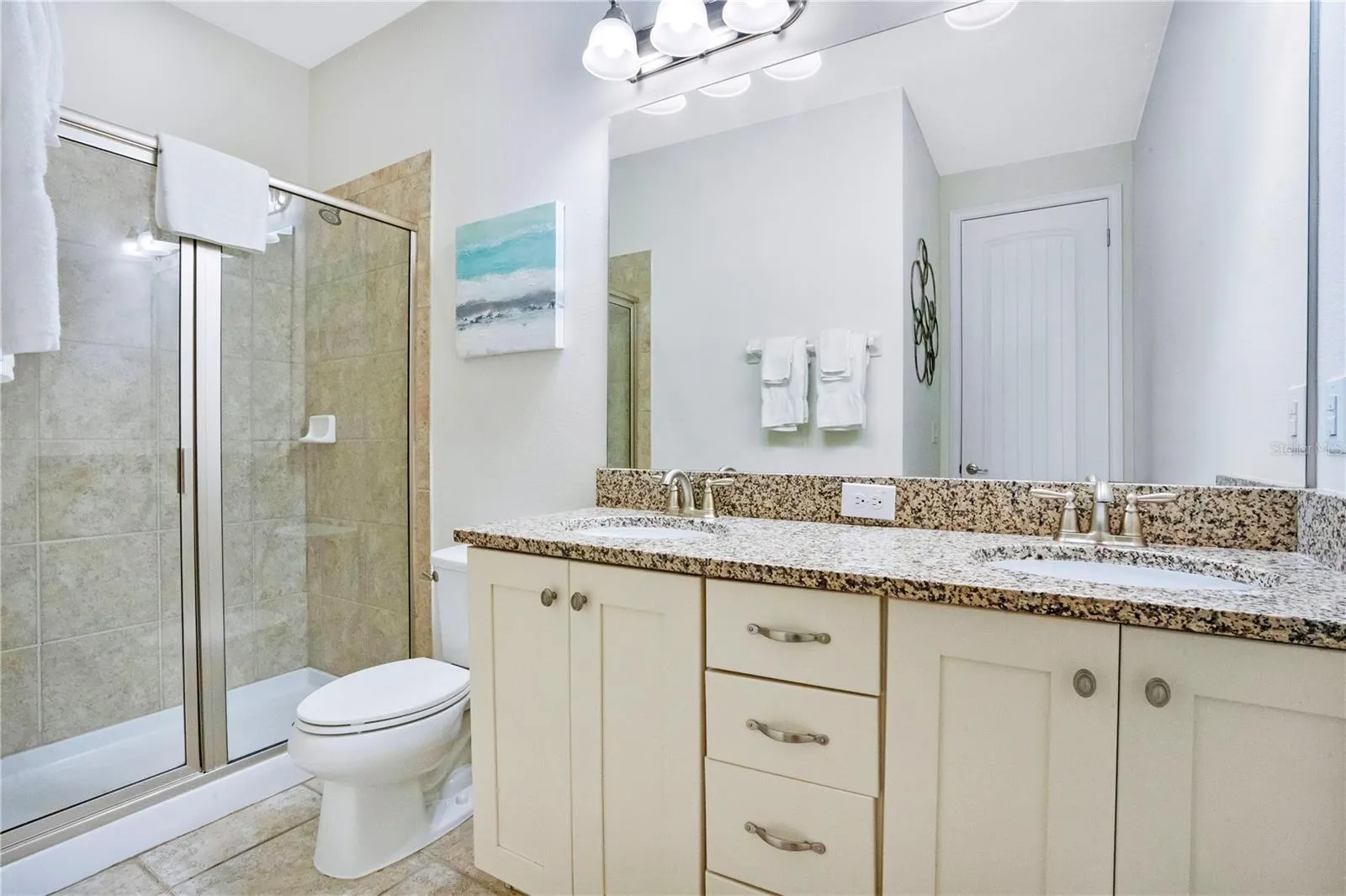 Private ensuite bath (#9) with clean modern finishes and generous vanity space