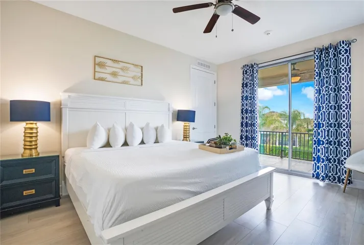 Elegant upstairs primary suite (#8) opening directly to the oversized screened balcony