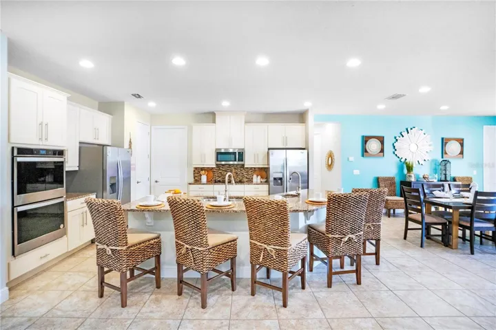 Spacious dining area positioned at the heart of the home with seating designed to comfortably accommodate large groups and vacation stays