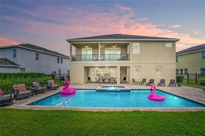 Expansive backyard retreat with heated pool and spa offering the perfect setting for relaxing after a day at Disney or enjoying evenings under the Florida sky