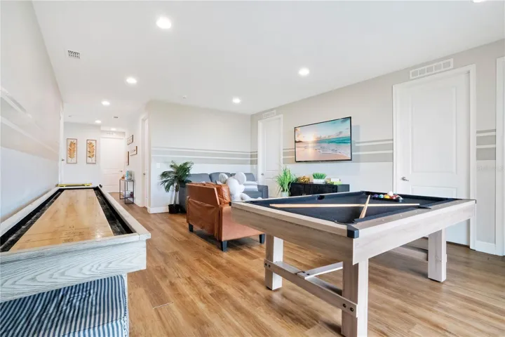 Expansive upstairs entertainment loft with brand-new pool table, shuffleboard, and classic Pac-Man cocktail arcade