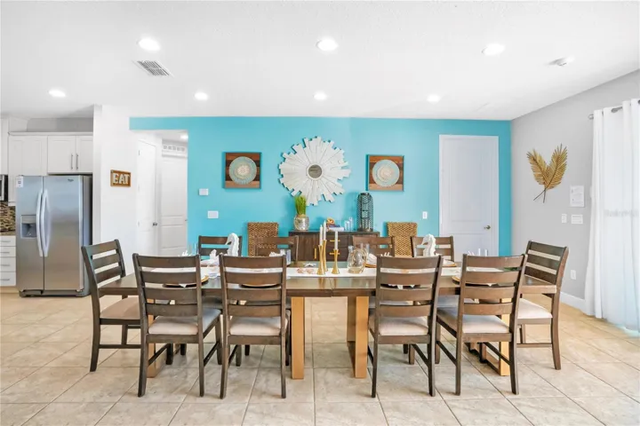 Expansive dining area with coastal-inspired styling and ample seating, perfectly suited for high-occupancy luxury vacation stays