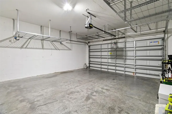 Two car garage with garage door opener & storage rack