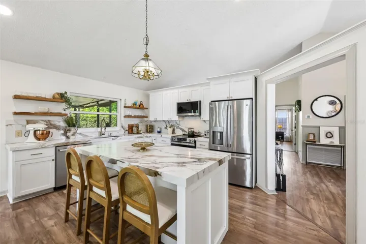 The REMODLED KITCHEN is truly the heart of the home, showcasing stylish quartz countertops, updated cabinetry, modern appliances and a seamless connection to the family room so everyone stays connected!