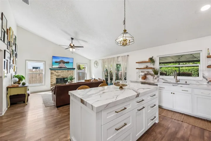 Kitchen is open to a light filled family room, complete with a vaulted ceiling.