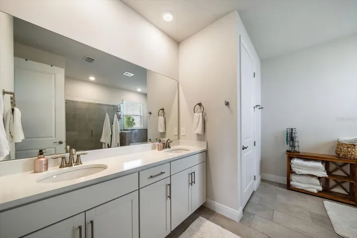 Master Bathroom with Dual Sinks and Custom Closets