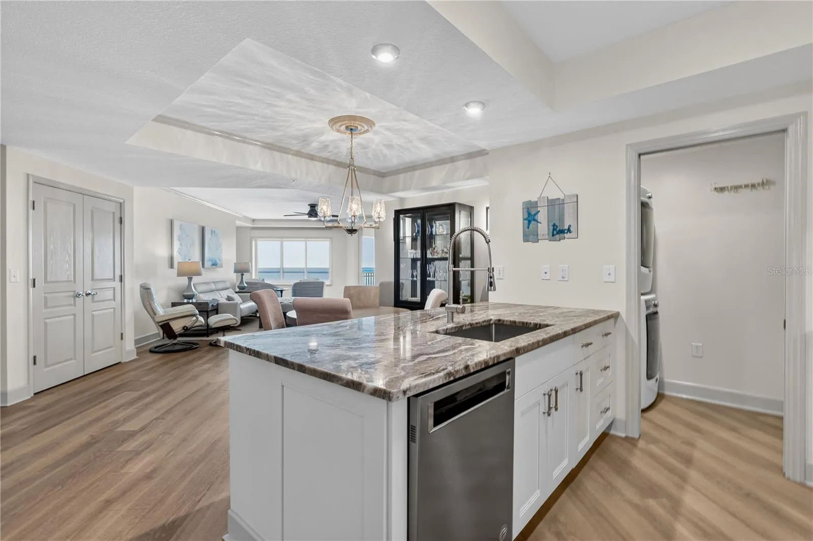 By opening the wall and extending the kitchen island, the design now draws your eye naturally toward the ocean views beyond.