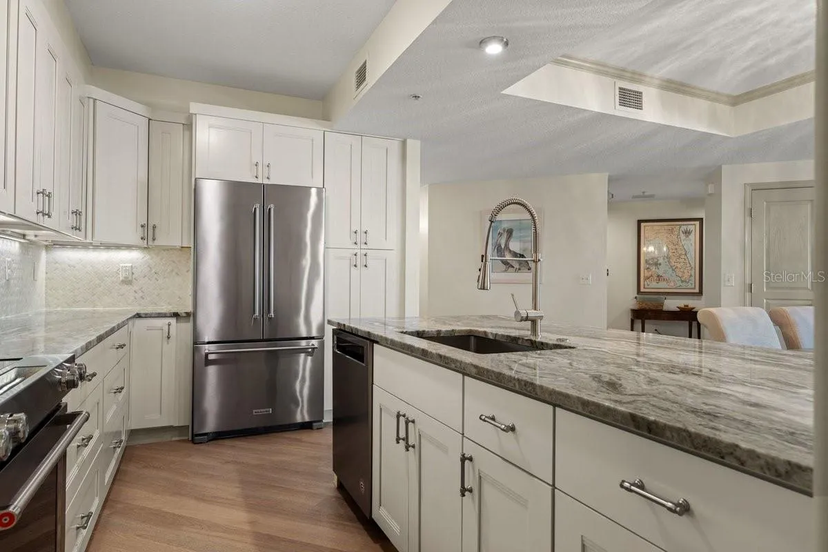 Outfitted with premium stainless steel appliances that complement the kitchen’s elevated custom design.