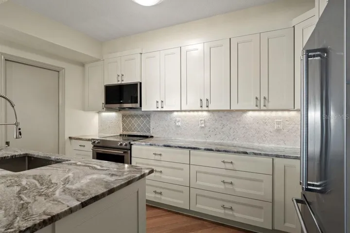 Designed with both style and practicality in mind, the kitchen offers exceptional storage.